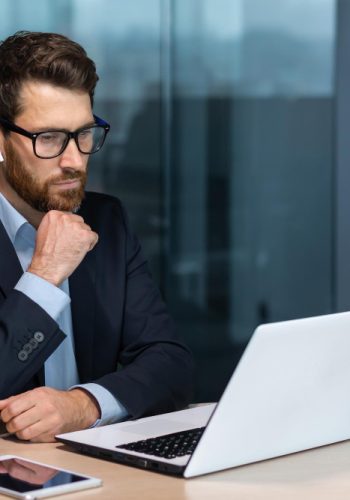 serious-thinking-mature-businessman-working-inside-modern-office-building-senior-boss-business